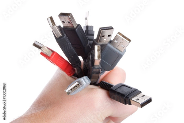 Obraz many usb cables in hand, isolated on white
