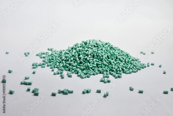 Fototapeta Mint green masterbatch granules on a white background, this polymer is a colorant for products in the plastics industry