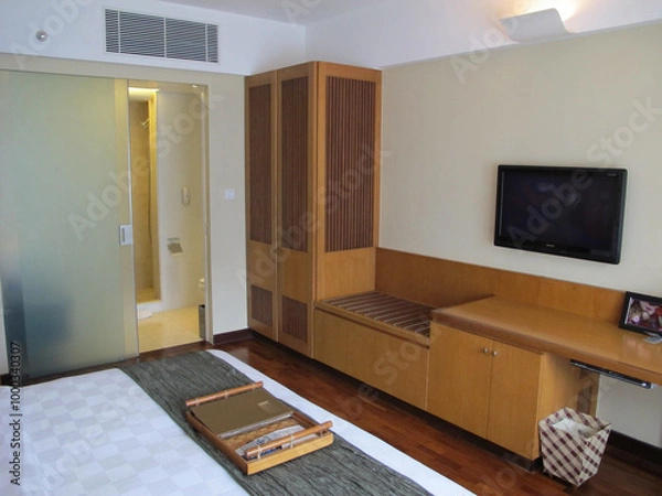 Fototapeta A hotel room interior with a minimalist design that offers comfort and tranquility, making it an ideal destination for a family vacation