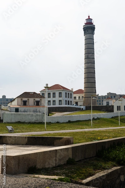 Fototapeta View of lighthouse, typical Portuguese architecture, with nice details and very particular framing, blue sky as background, located in Leça da Palmeira, Porto, Portugal. Matosinhos. Leça Beach