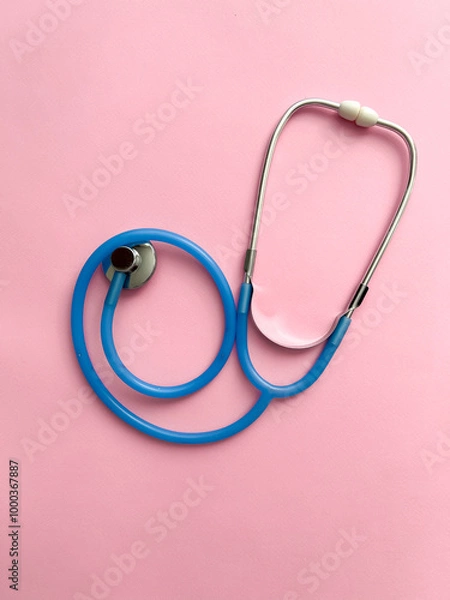 Fototapeta Doctor concept. Top view of stethoscope on pink background with space for text or promotion