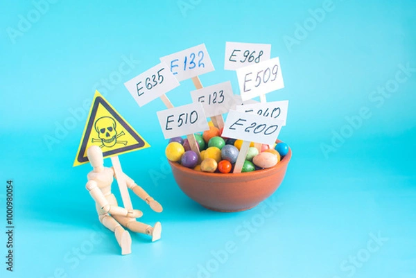 Fototapeta A cup with various food additives in close-up on a light background. Warning about the deadly dangers of uncontrolled use of dietary supplements
