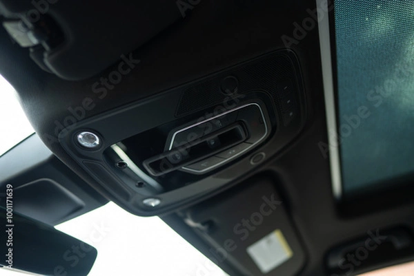Fototapeta Close up view of interior cabin lights with dome-shaped cover attached to ceiling of modern car. Overhead controls of turning on or off illumination in cabin of vehicle
