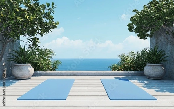 Fototapeta Serene outdoor yoga space with blue mats and ocean view under clear sky.