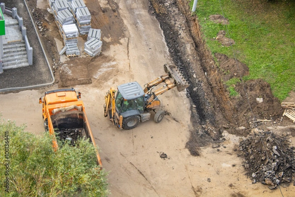 Fototapeta Aerial view of a construction site with dump truck and bulldozer