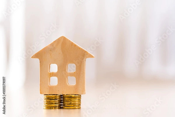 Obraz Home model put on the stack gold coin on sunlight in the office, Loan for real estate or saving money for buy a new house to family in the future concept.