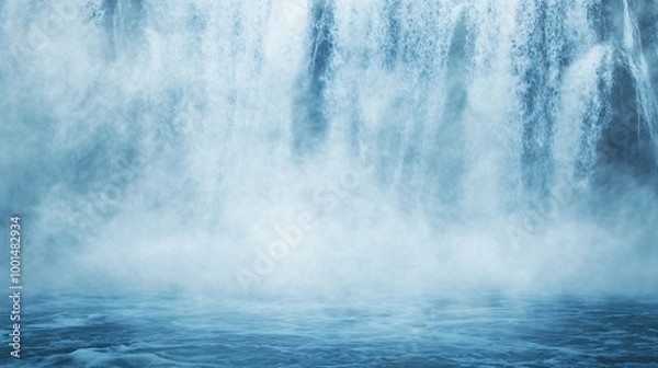 Fototapeta Misty waterfall cascading into calm blue water.