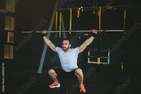 Obraz man in a gym exercising