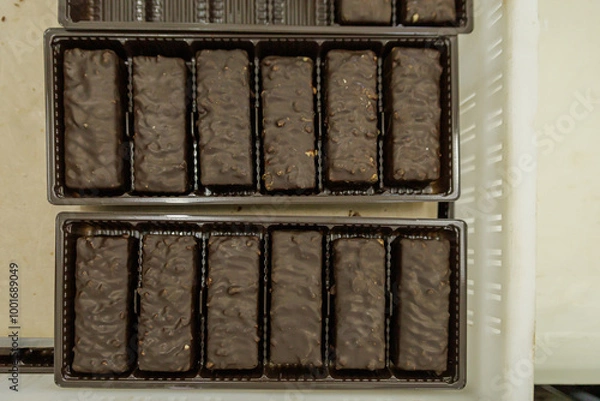 Fototapeta Top view of chocolate sweets in boxes.