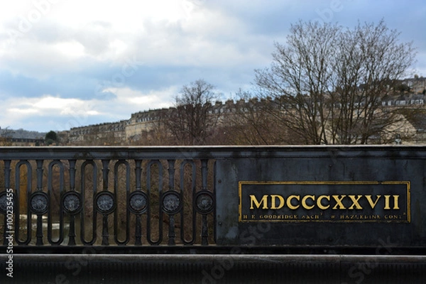 Fototapeta Roman numerals on bridge in Bath, UK. Bridge built in 1827 between Cleveland Place and Bathwick Street in Bath, UK.
