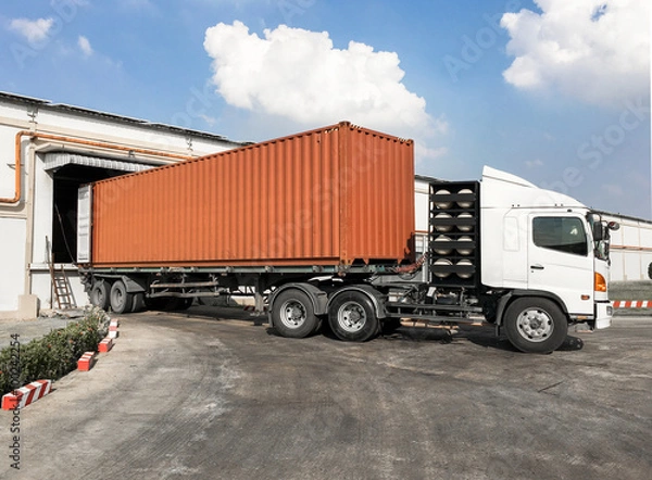 Fototapeta Container truck loading goods at warehouse