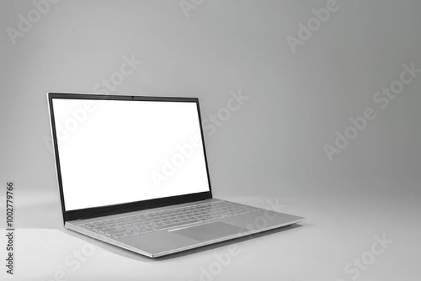 Obraz A laptop with a white screen sits on a grey surface