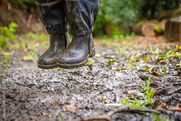 Obraz Child in welly boots, jump, jumping in mud.