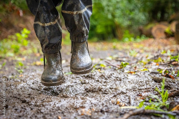 Obraz Child in welly boots, jump, jumping in mud.