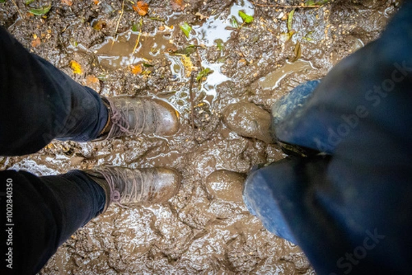 Fototapeta Child in welly boots, jump, jumping in mud.