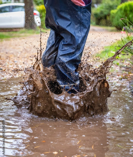 Obraz Child in welly boots, jump, jumping in mud.