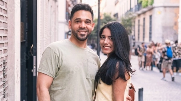 Fototapeta Happy couple standing together in city during daytime
