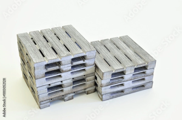 Fototapeta Two stacks of wooden pallets