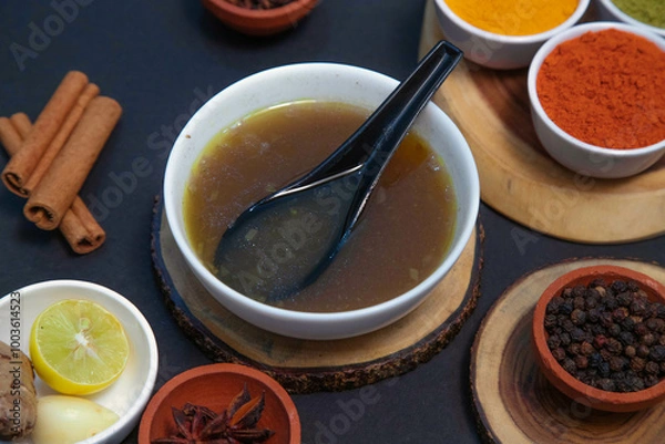 Fototapeta mutton soup, chicken soup, vegetable soup along with onion or creamy onion raita, lemon, Star anise, cinnamon, pepper, clove, chutney, chicken gravy and spices on white bowl