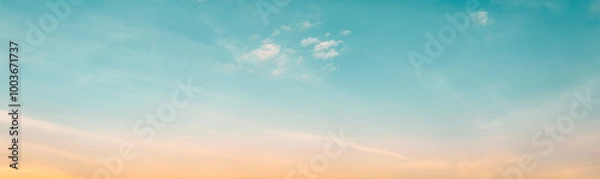 Fototapeta The clear teal blue sky with white clouds provides a bright and sunny background, enhancing the natural beauty of the landscape on this pleasant summer day
