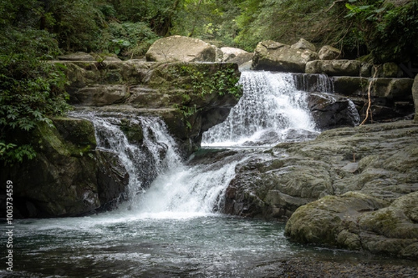 Fototapeta River goes like stair from the beautiful shape rocks, hidden in the forest, in Manyueyuan Forest Recreation Area, New Taipei City, Taiwan.