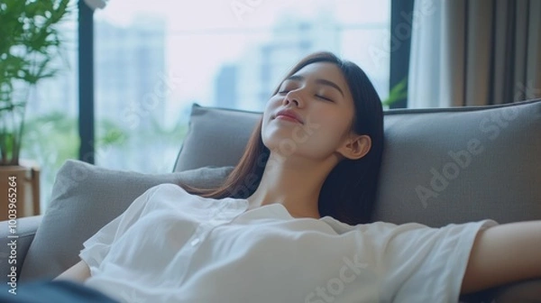 Obraz A content woman relaxing with her eyes closed, a picture of urban serenity and modern living.