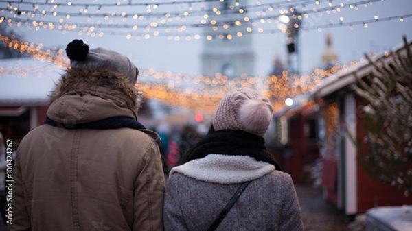 Obraz Young couple strolling during winter holidays