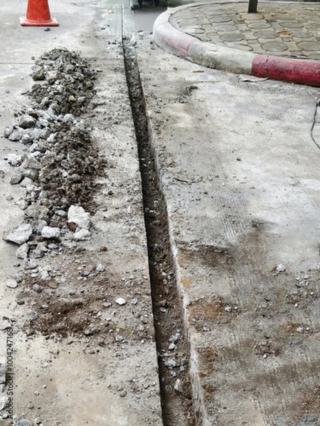 Obraz Concrete road cutting work to install electrical systems
