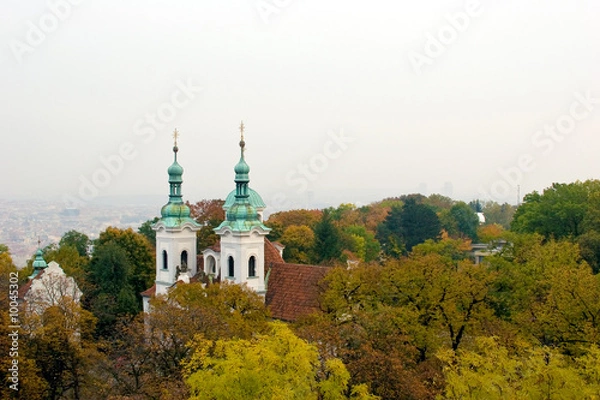 Fototapeta Copper topped castle set among fall colored trees