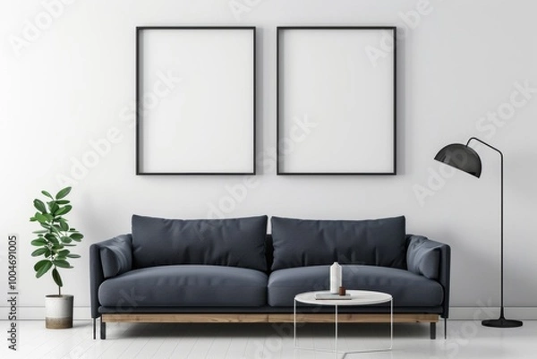 Fototapeta White wall with two blank poster frames, modern interior design of dark blue sofa and coffee table near it, wooden elements, black lamp on the side, minimalistic style