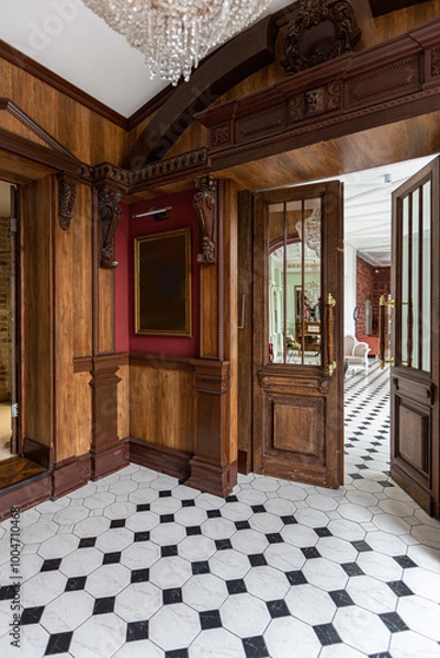 Obraz the chic expensive interior of the living room in the historical Baroque style, tiles on the floor, walls decorated with wood. the furniture is in a historical style.