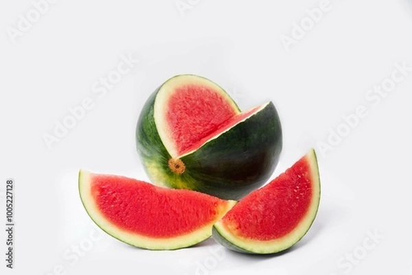 Fototapeta Whole watermelon and seeded slices seen front and top on a white background. Watermelon slices are red, seedy and juicy.