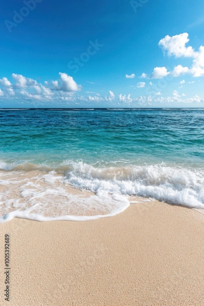 Fototapeta Ocean waves breaking on sand at tropical beach for vertical background
