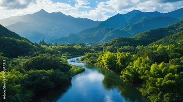 Fototapeta Stunning view of the Azusa River winding through the lush greenery of KamikAchi, with the Hotaka Mountains towering in the background, creating a serene and scenic landscape.