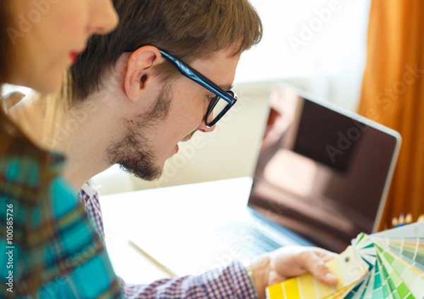 Obraz Young colleague - manand woman looking to a color paint palette