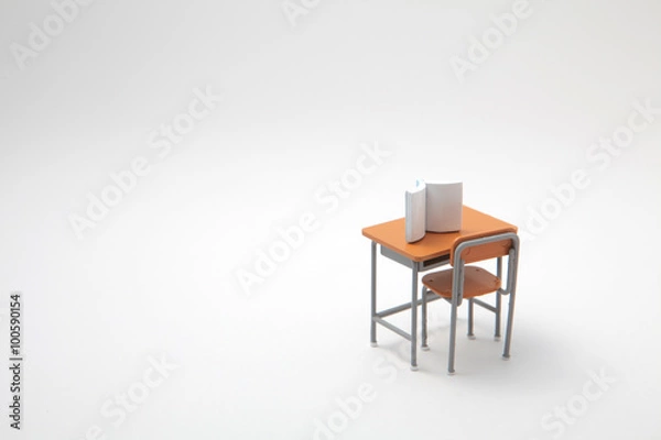 Fototapeta Book and miniature learning desk  on white background