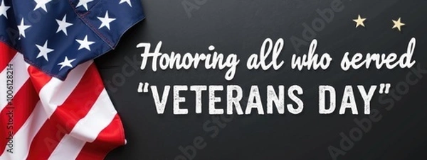 Fototapeta An American flag draped over a black chalkboard, with the text "Honoring all who served, Veterans Day" written in white chalk on the board.