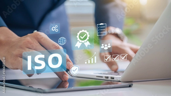 Obraz ISO certification and quality management concept. Business professional reviewing ISO certification standards with digital icons representing quality control, management, and compliance processes.