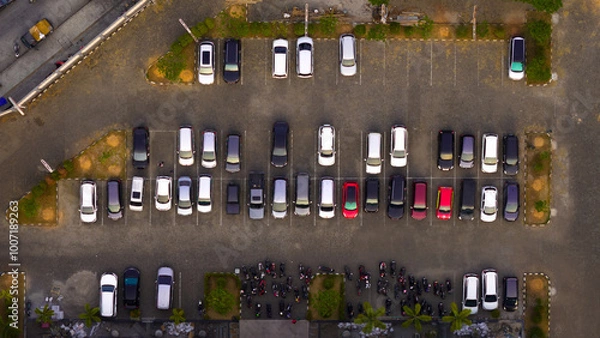 Obraz Bird's eye view of an orderly urban parking lot filled with cars, showcasing everyday organization and city life