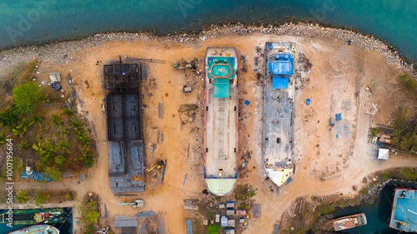 Obraz Aerial view of a bustling shipyard with vessels in various stages of construction and repair