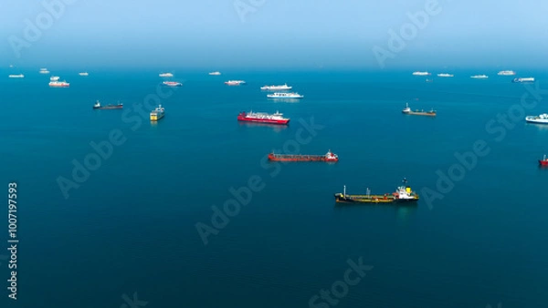 Obraz Serene seascape with a fleet of cargo ships dotting the tranquil blue ocean, capturing the essence of maritime logistics and global trade