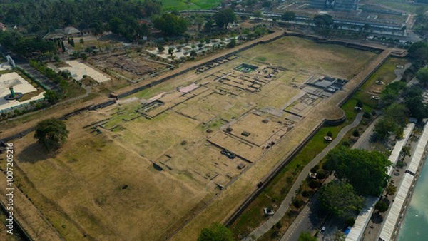 Fototapeta Aerial view showcasing the intricate layout of an ancient archaeological site bordered by modern development