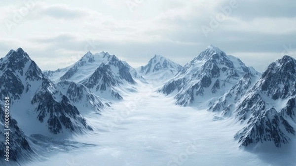 Fototapeta A vast, snow-covered mountain range with a clear blue sky in the background