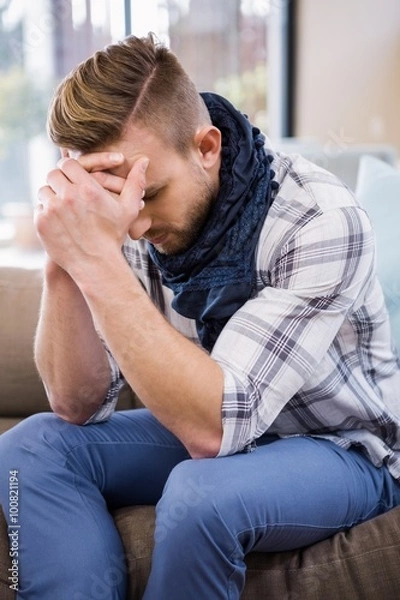 Fototapeta Worried man thinking on the couch 