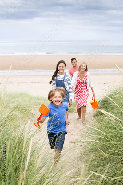 Obraz Family walking up the sand dunes