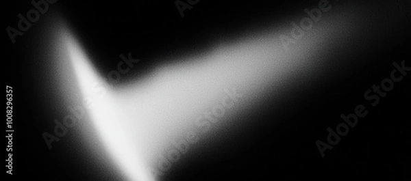 Fototapeta A abstract black and white image showcasing a gradient of light forming a soft, subtle shape against a dark background.