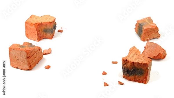 Obraz Fragments of shattered brick isolated over white