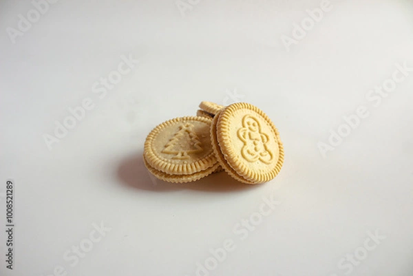 Fototapeta Round cookies with including Christmas symbols such as trees, snowmen and other holiday characters. Vanilla or butter sandwich cookies.