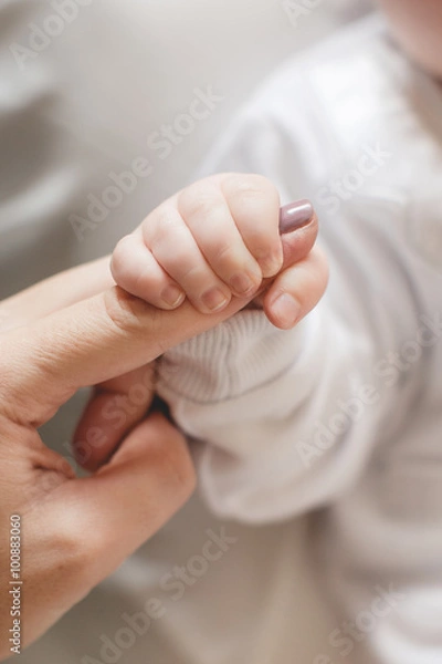 Obraz Newborn baby holding mother's finger