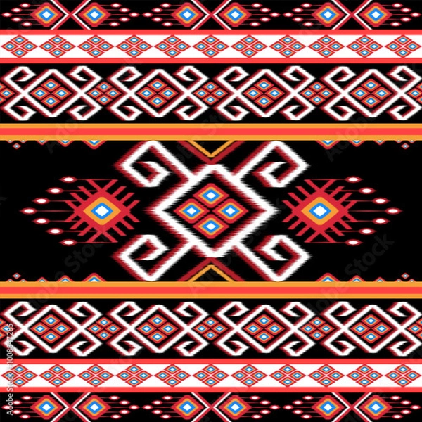 Fototapeta Bold ethnic Ikat pattern featuring red, white, and gold geometric shapes with diamond and heart motifs on a black background. Ideal for fabric design, home decor, and fashion with a tribal-inspired 